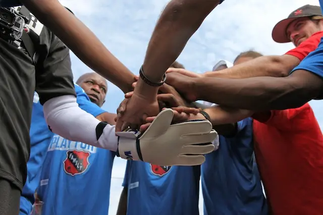A team huddles at the Street Soccer USA National Cup.